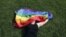 A woman with a rainbow flag lays on grass during the LGBT (lesbian, gay, bisexual, and transgender) community rally "VIII St.Petersburg Pride" in St. Petersburg, Russia August 12, 2017. REUTERS/Anton Vaganov