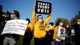 Pennsylvania, U.S. - People hold signs as they take part in a rally demanding a fair count of the votes of the 2020 U.S. presidential election, in Philadelphia