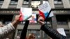 Russia -- Participants hold booklets containing the Constitution of the Russian Federation during a protest against a housing resettlement program outside the building of the State Duma, in central Moscow, June 14, 2017