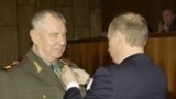 Russia -- Russian President Vladimir Putin (R) awards Marshal Dmitry Yazov with the Order of Honor, Moscow, November 17, 2004