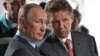 RUSSIA -- Russian President Vladimir Putin (L) and Gazprom Management Committee Chairman Alexei Miller (R) visit the Amur Gas Processing Plant construction site near the town of Svobodny on the banks of the Zeya River about 170 km north of the city of Bla