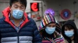 RUSSIA -- People walk past a currency exchange office in Moscow on March 12, 2020, wearing medical masks, amid a spread of COVID-19, the new coronavirus.