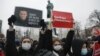 RUSSIA – People gather during a protest against the jailing of opposition leader Alexei Navalny in Pushkin square at the statue of Alexander Pushkin in the background in Moscow, Jan. 23, 202