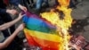 Ukraine -- Anti-LGBT protesters burn an LGBT flag during the opening ceremony of Kyiv Pride 2017 in Kyiv, June 13, 2017