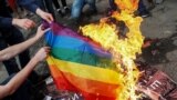 Ukraine -- Anti-LGBT protesters burn an LGBT flag during the opening ceremony of Kyiv Pride 2017 in Kyiv, June 13, 2017