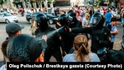 Riot police spray tear gas in the faces of protesters in Brest at a peaceful protest against the government on September 20, 2020.