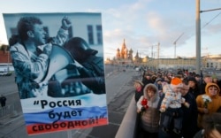 A poster at a February 27, 2016 memorial demonstration for Boris Nemtsov in Moscow reads ‘Russia will be free!’.