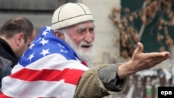 A Georgian demonstrator, known for his affinity for the U.S. flag, attends a 2014 anti-Russia rally in Tbilisi, Georgia. 