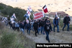 Carrying a sign that reads "Davit Gareji is Georgia," the Georgian March, a group of ultranationalists that shares Kremlin suspicions of the West, staged a rally at the monastery complex on October 9, 2020.