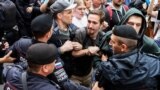 RUSSIA -- Opposition activists clash with police as they attend a rally against efforts to stop opposition candidates to register for the elections to the Moscow City Duma during a march in central Moscowm July 14, 2019