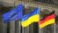 GERMANY – The Ukrainian national flag waves betwen the Europa fag, left, and the German national flag, right, in front of the Reichstag building during a debate at the German parliament Bundestag in Berlin, June 1, 2022