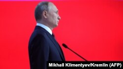 Russian President Vladimir Putin listens to the national anthem at the end of his annual state-of-the-nation address in Moscow on February 20. 