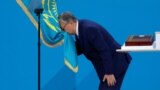 KAZAKHSTAN -- Kazakh President-elect Qasym-Zhomart Toqaev kisses the state flag during his inauguration ceremony in Nur-Sultan, June 12, 2019