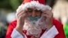 Spain - A swimmer in a Santa Claus costume prepares to participate in the 111th edition of the Copa Nadal (Christmas Cup) swimming race in Barcelona's Port Vell on December 25, 2020