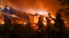 U.S.-- Firefighters battle the Woolsey Fire burning a home in Malibu, Calif., Friday, Nov. 9, 2018