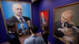 RUSSIA -- People look at the paintings depicting Russian president Vladimir Putin at the "SUPERPUTIN" exhibition in UMAM museum in Moscow, Russia, December 6, 2017