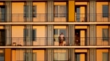 ROMANIA -- A Romanian man watches the sunset from the balcony of his flat in Bucharest, April 6, 2020