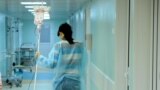 Russia -- A woman carries a dropper of her daughter, patient of the oncology unit, in the RDKB (a cyrillic acronym for Russian Children's Clinical Hospital) in Moscow, November 10, 2011 