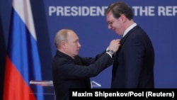 Президент Сербии Александр Вучич принимает Орден Александра Невского от российского президента Владимира Путина во время их встречи в Белграде в январе 2019 года