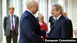 Belarusian President Alyaksandr Lukashenka (left) meets with EU enlargement commissioner Johannes Hahn in Minsk last year. 