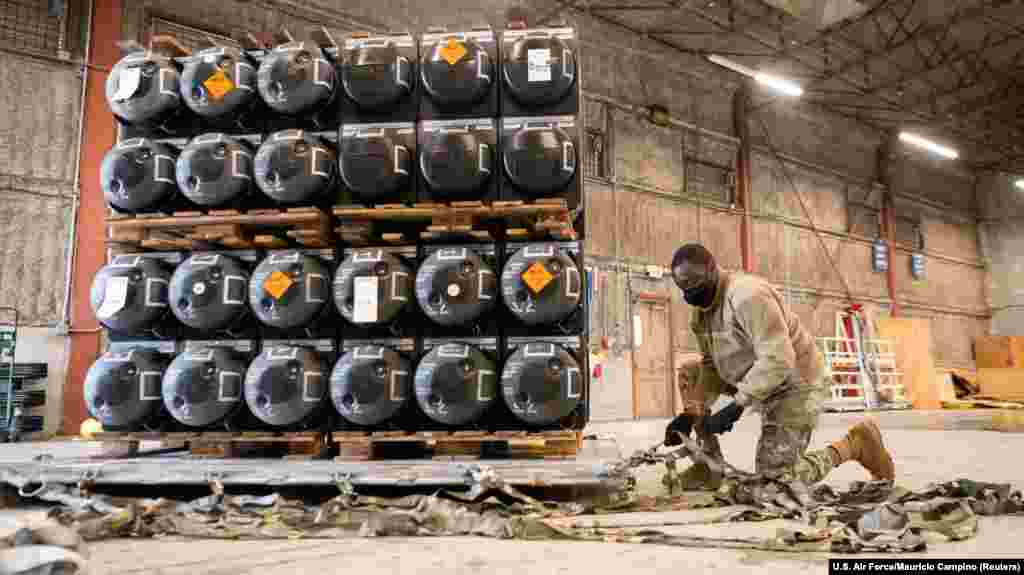 A U.S. airman prepares a pallet of ammunition, weapons, and other military supplies bound for Ukraine at Dover Air Force Base in Delaware on January 21.&nbsp;