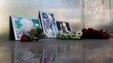 RUSSIA -- Photographs of journalists, (R-L) Orhan Dzhemal, Kirill Radchenko and Aleksandr Rastorguyev, who were recently killed in Central African Republic by unidentified assailants, are on display outside the Central House of Journalists in Moscow, Augu