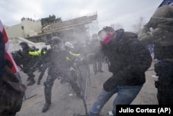 Supporters of Republican President Donald Trump try to break through a police barrier on January 6, 2021 at the U.S. Capitol, where thousands of people gathered to contest Democratic presidential candidate Joe Biden's win of the 2020 U.S. presidential election.