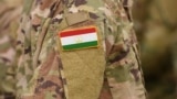Tajikistan flag on soldiers arm (collage).