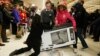U.K. -- Shoppers wrestle over a television as they compete to purchase retail items on "Black Friday" at an Asda superstore in Wembley, north London November 28, 2014. Britain's high streets, malls and online sites were awash with discounts on Friday as m