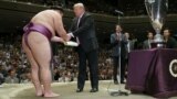 U.S. President Donald Trump prepares to present the President’s Cup to wrestler Asanoyama, the winner of the Summer Grand Sumo Tournament at Ryogoku Kokigikan Sumo Hall in Tokyo, Japan May 26, 2019. REUTERS/Jonathan Ernst