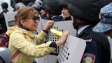 Kazakhstan Election - A woman speaks to Kazakh police during an anti-government protest during the presidential elections in Nur-Sultan, the capital city of Kazakhstan, Sunday, June 9, 2019. Voters in Kazakhstan are choosing a successor to the president w