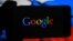 RUSSIA  -- A person holds a smartphone showing a Google logo, in front of a computer screen showing a Russian national flag, St. petersburg, November 16, 2016