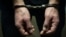 The arrested criminal handcuffed. Hands with handcuffs in the front