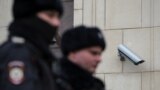 Police officers walk past a surveillance camera in central Moscow, Russia January 26, 2020. Picture taken January 26, 2020. REUTERS/Shamil Zhumatov