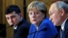 FRANCE -- Ukraine's President Volodymyr Zelenskiy, German Chancellor Angela Merkel and Russia's President Vladimir Putin attend a joint news conference after a Normandy-format summit in Paris, France December 10, 2019. 