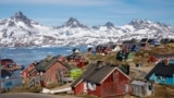 GREENLAND -- Snow covered mountains rise above the harbour and town of Tasiilaq, Greenland, June 15, 2018. REUTERS/Lucas Jackson/File Photo