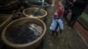 CZECH REPUBLIC -- A child looks at carp in tubs at a street sale in downtown Prague, December 22, 2017
