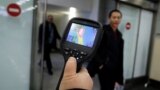 Kazakhstan - Kazakh sanitary-epidemiological service worker uses a thermal scanner to detect travellers from China who may have symptoms possibly connected with the previously unknown coronavirus, at Almaty International Airport, Kazakhstan January 21, 20