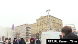 Current Time correspondent Aleksei Aleksandrov (bottom right) shows an unmarked white van equipped with a surveillance camera in downtown Moscow during the city's January 31, 2021 protest for the release of Aleksei Navalny.