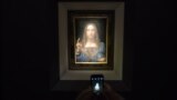 U.S. -- visitor takes a photo of the painting 'Salvator Mundi' by Leonardo da Vinci at Christie's New York Auction House, in New York, November 15, 2017