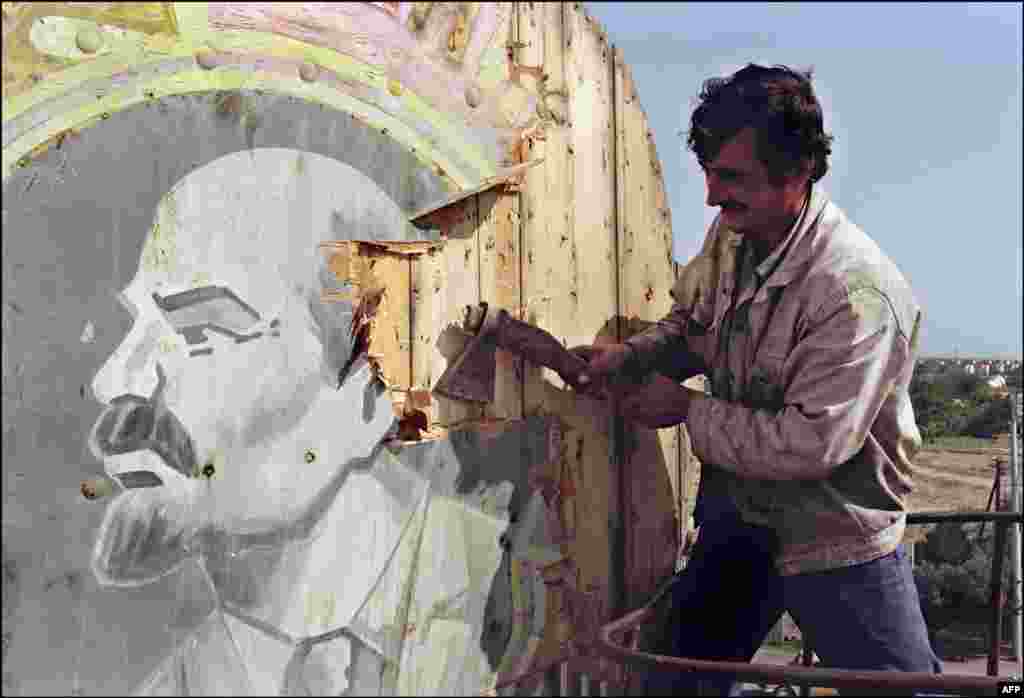 A resident of Baku tears down a portrait of Lenin on September 21, 1991, nearly a month after Azerbaijan&#39;s&nbsp;declaration of independence at the end of August.