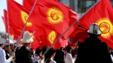 KYRGYZSTAN -- Citizens wave Kyrgyz state flags as they take part in a procession marking the 'National Flag and white Kalpak Day' in central Bishkek, March 5, 2018