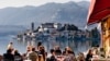 LAKE ORTA, ITALY - FEB 24: People in a restaurant in Orta on February 24, 2012. With the nearby Unesco site Sacro Monte and San Giulio island, Orta is a popular destination for small-scale tourism.