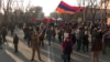A protester waves the Armenian flag in downtown Yerevan on March 1 at ongoing demonstrations for Armenian Prime Minister Nikol Pashinian's resignation. 