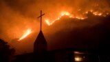 U.S. -- Flames from a wildfire advance down a hillside near the Springs of Life Church in Casitas Springs, Calif., on Tuesday, Dec. 5, 2017.