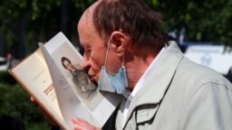 Мужчина целует портрет поэта Александра Пушкина во время празднования Дня русского языка. Фото: ТАСС