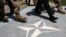 AFGHANISTAN -- U.S. Defence Secretary James Mattis (C) walks with U.S. Army personnel across a NATO logo as he arrives at Resolute Support headquarters in Kabul, April 24, 2017