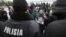 KAZAKHSTAN -- Participants stand in front of Kazakh police officers during a meeting in memory of anti-government activist Dulat Agadil, who recently died in a police detention center, in Almaty, February 27, 2020