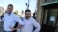 RUSSIA -- Russian opposition leader Aleksei Navalny (L) and Leonid Volkov stand near the Open Russia movement office during Russian regional elections in the town of Kostroma, September 13, 2015