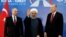 IRAN - Turkish President Recep Tayyip Erdogan (right) , Iranian President Hassan Rouhani (center) and Russian President Vladimir Putin (left) greeting the media during a trilateral summit in Tehran, September 7, 2018
